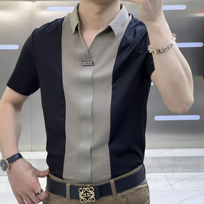 Man wearing black and beige short-sleeve shirt with logo pin, paired with brown pants and black belt