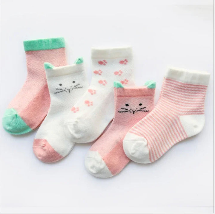 Five pairs of pastel-colored baby socks with cat ears, paw prints, and stripes on white background