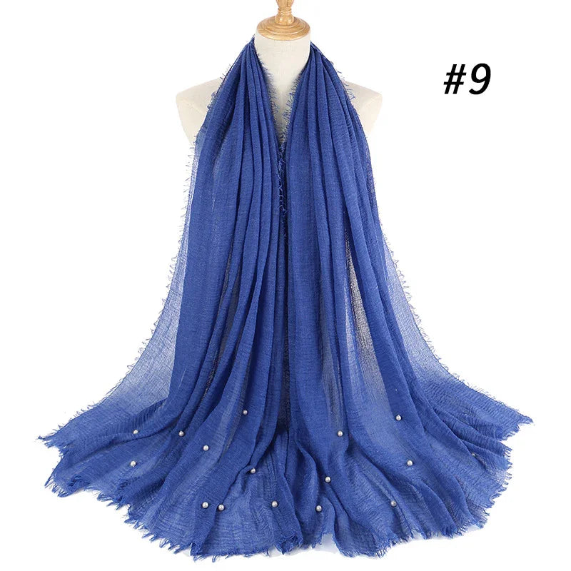 Blue lightweight scarf with small white bead embellishments displayed on mannequin