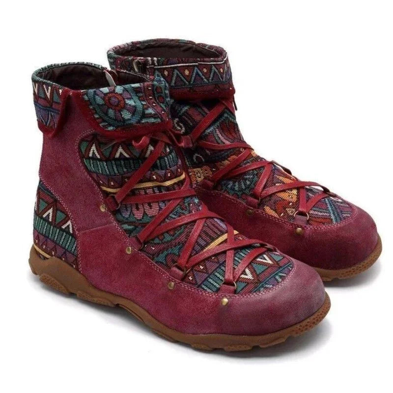 Pair of maroon suede ankle boots with colorful geometric woven fabric and brown rubber soles