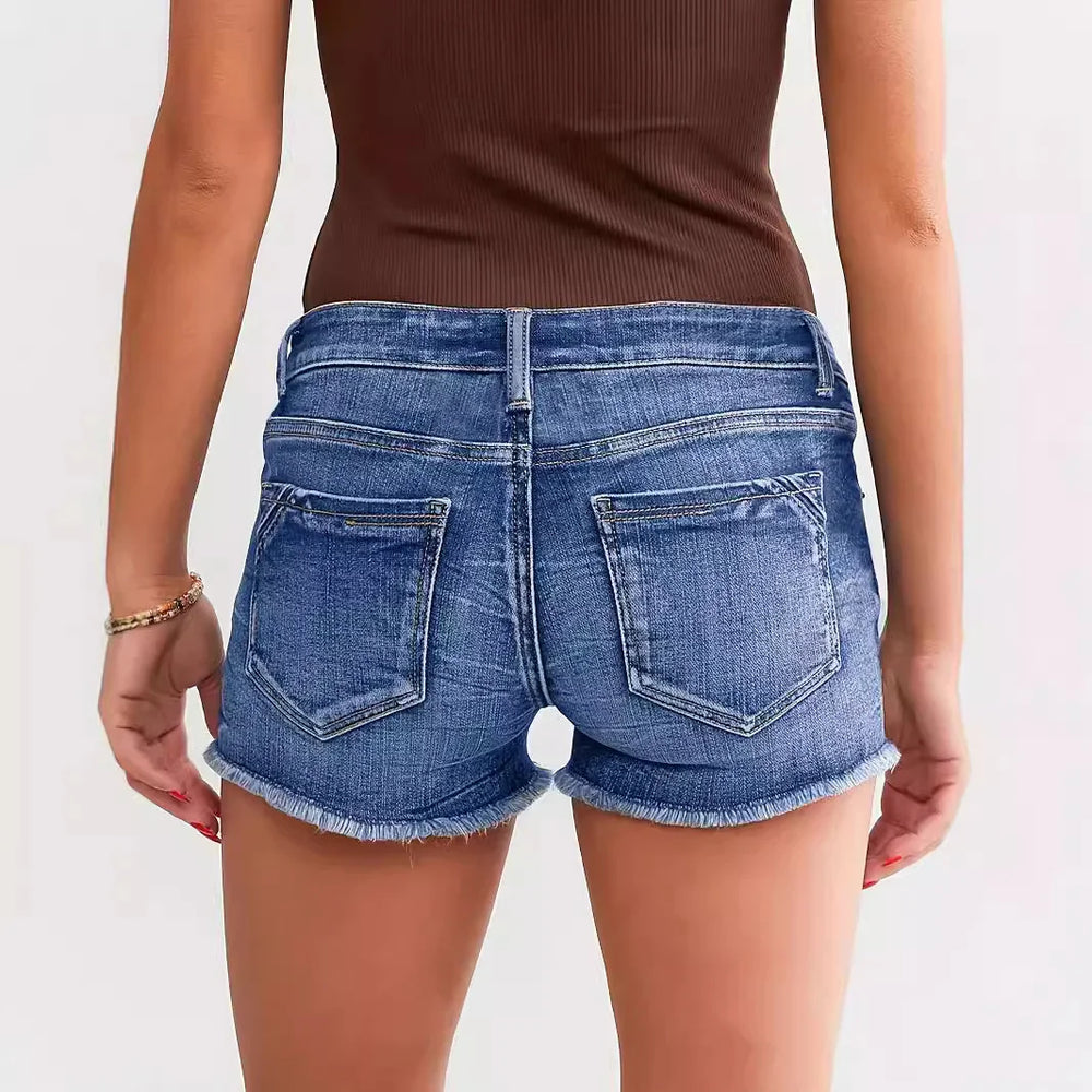 Back view of woman wearing blue denim shorts with frayed hem and brown sleeveless top