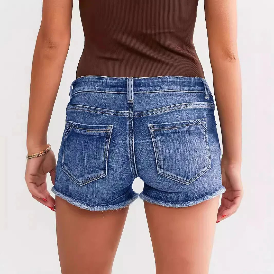 Back view of woman wearing blue denim shorts with frayed hem and brown sleeveless top
