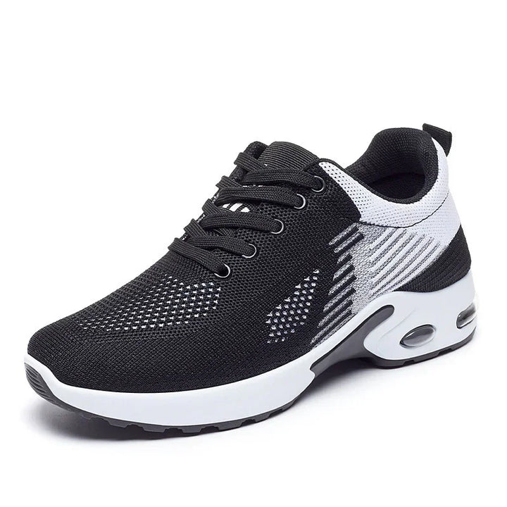 Black and white breathable knit athletic sneaker with air-cushioned sole and lace-up design