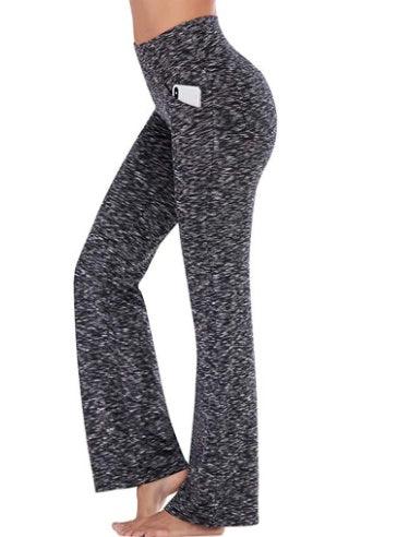 Woman wearing high-waisted black and white marled yoga pants with side phone pocket
