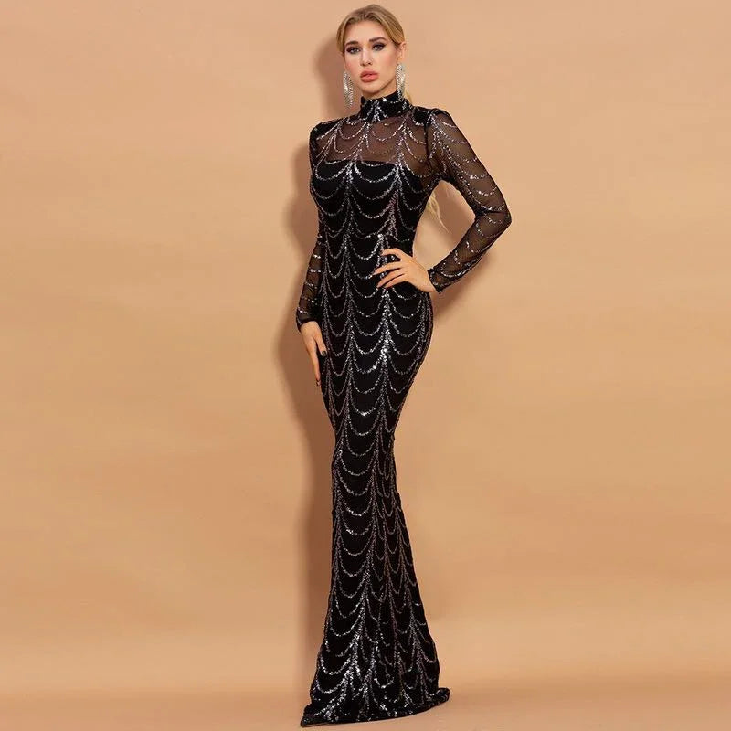 Blonde woman in a long black sequin evening gown with sheer sleeves against beige background