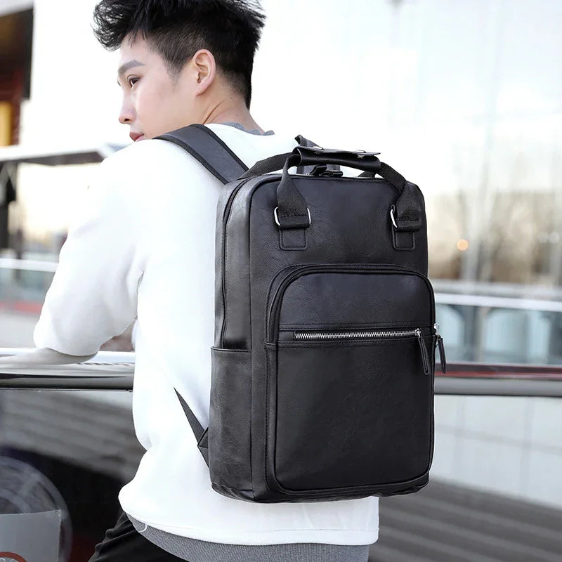 Young man wearing a stylish black leather backpack with front zipper pocket outdoors
