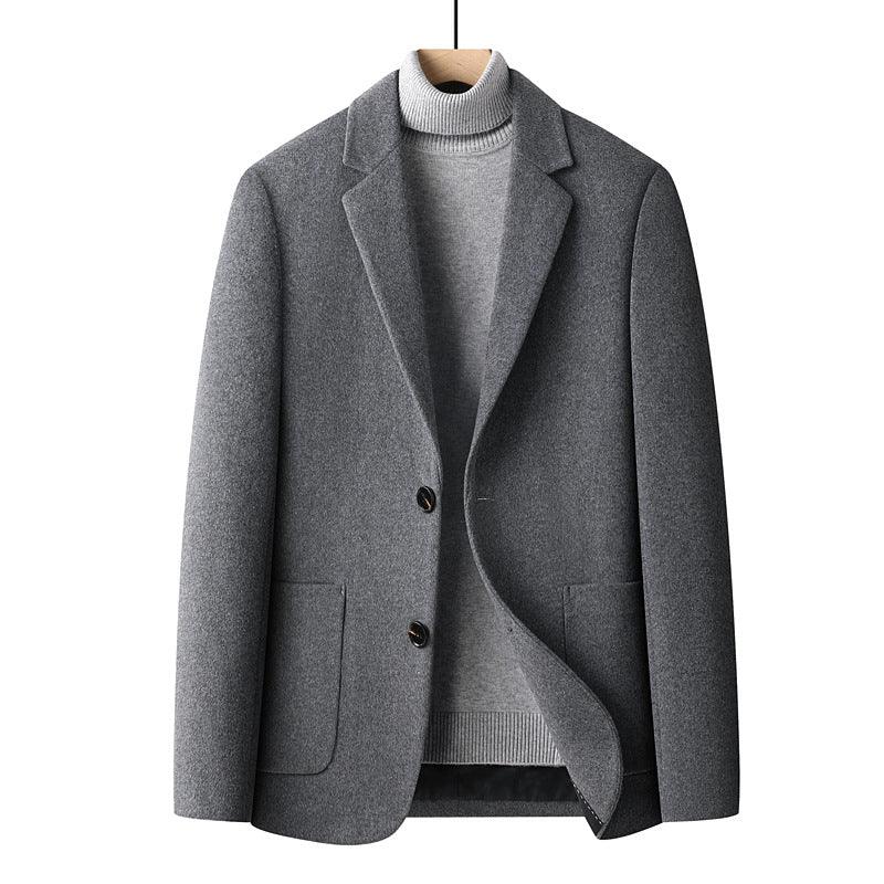 Gray wool blazer jacket layered over light gray turtleneck sweater on wooden hanger