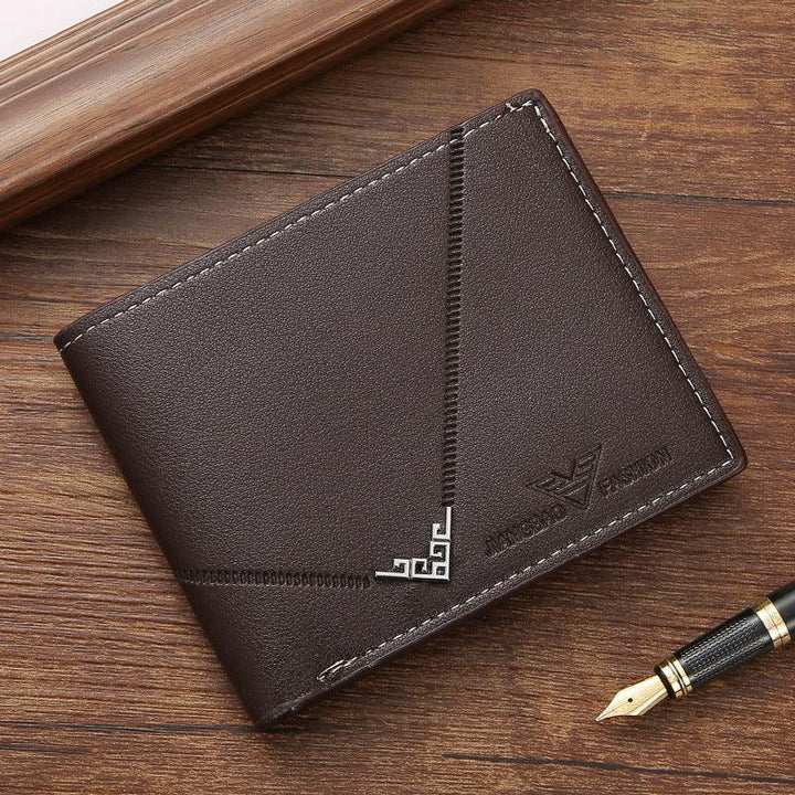 Brown leather men's wallet with decorative stitching and embossed logo on wooden surface with fountain pen