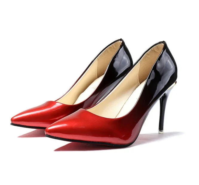 Stylish women's pointed-toe high heels with red front and black glossy back on white background