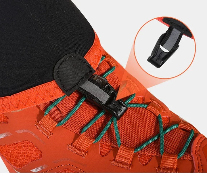 Close-up of orange hiking shoe with green laces and black quick-release buckle fastening detail
