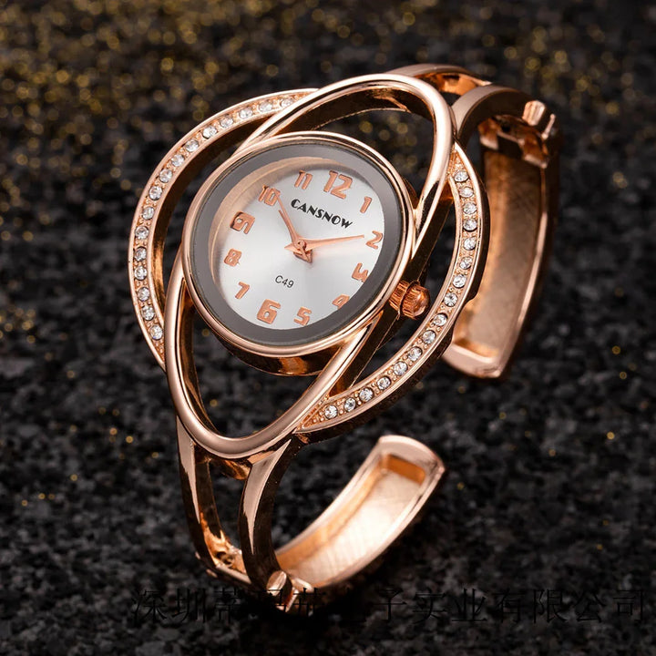 Elegant rose gold CANSNOW wristwatch with crystal-studded oval bracelet on dark surface