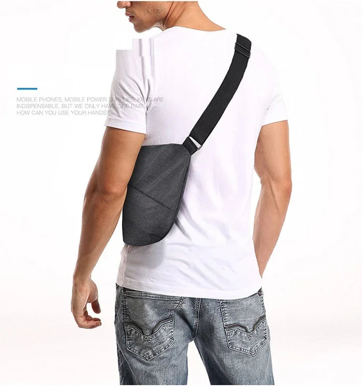 Man wearing casual white t-shirt and jeans with black crossbody sling bag on back