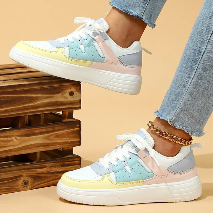 Casual pastel color block sneakers with white soles worn with frayed hem light blue jeans and gold anklet