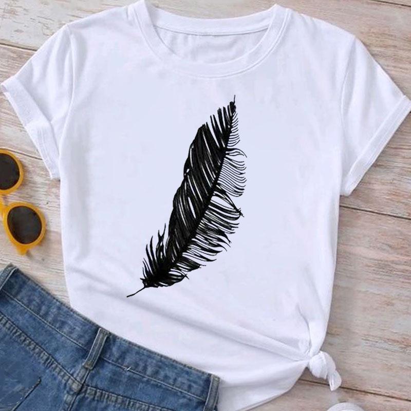 White t-shirt with black feather print laid flat with blue jeans and yellow sunglasses on wooden background