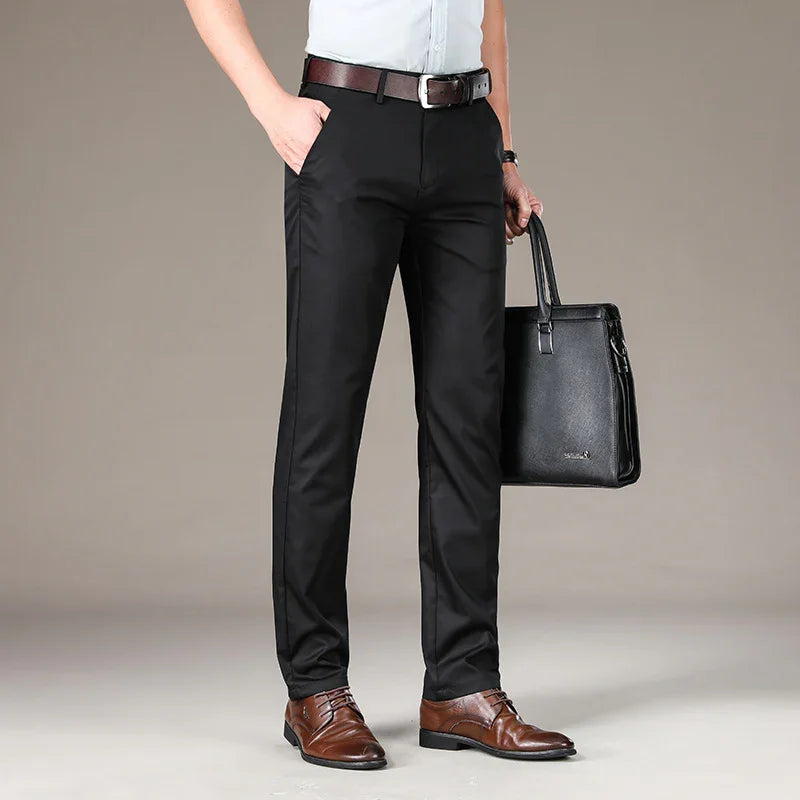 man wearing black dress pants, brown leather belt, brown dress shoes, holding black leather briefcase