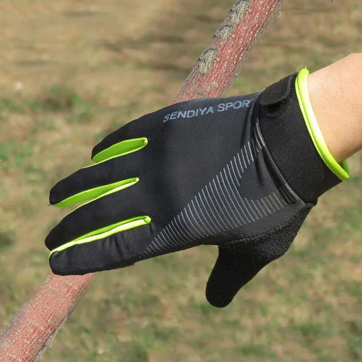Black and neon yellow SENDIYA SPORT glove gripping a red wooden stick outdoors on grass background