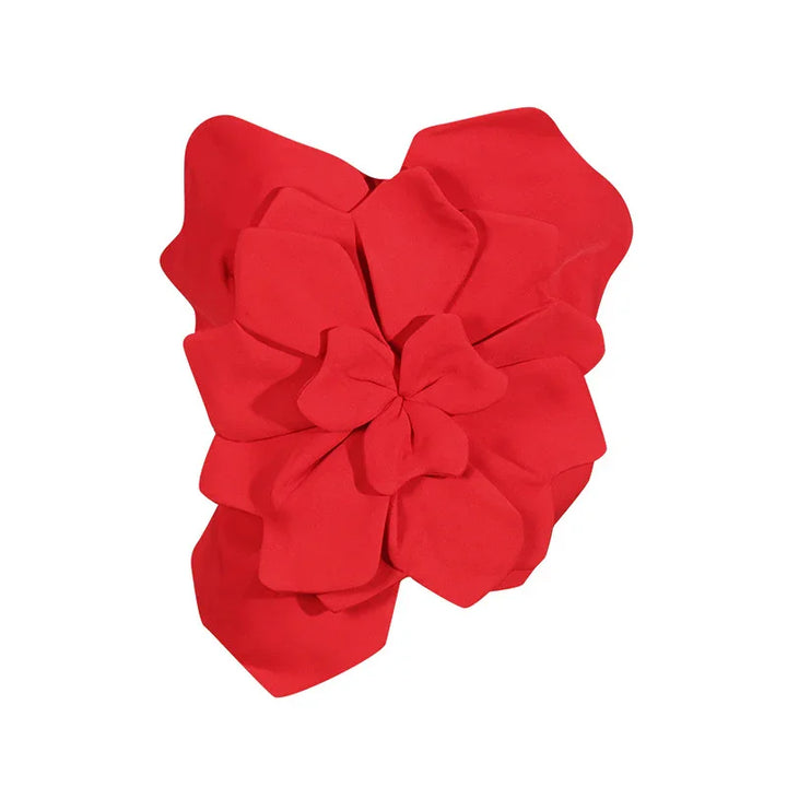 Red fabric flower accessory with layered petals on white background