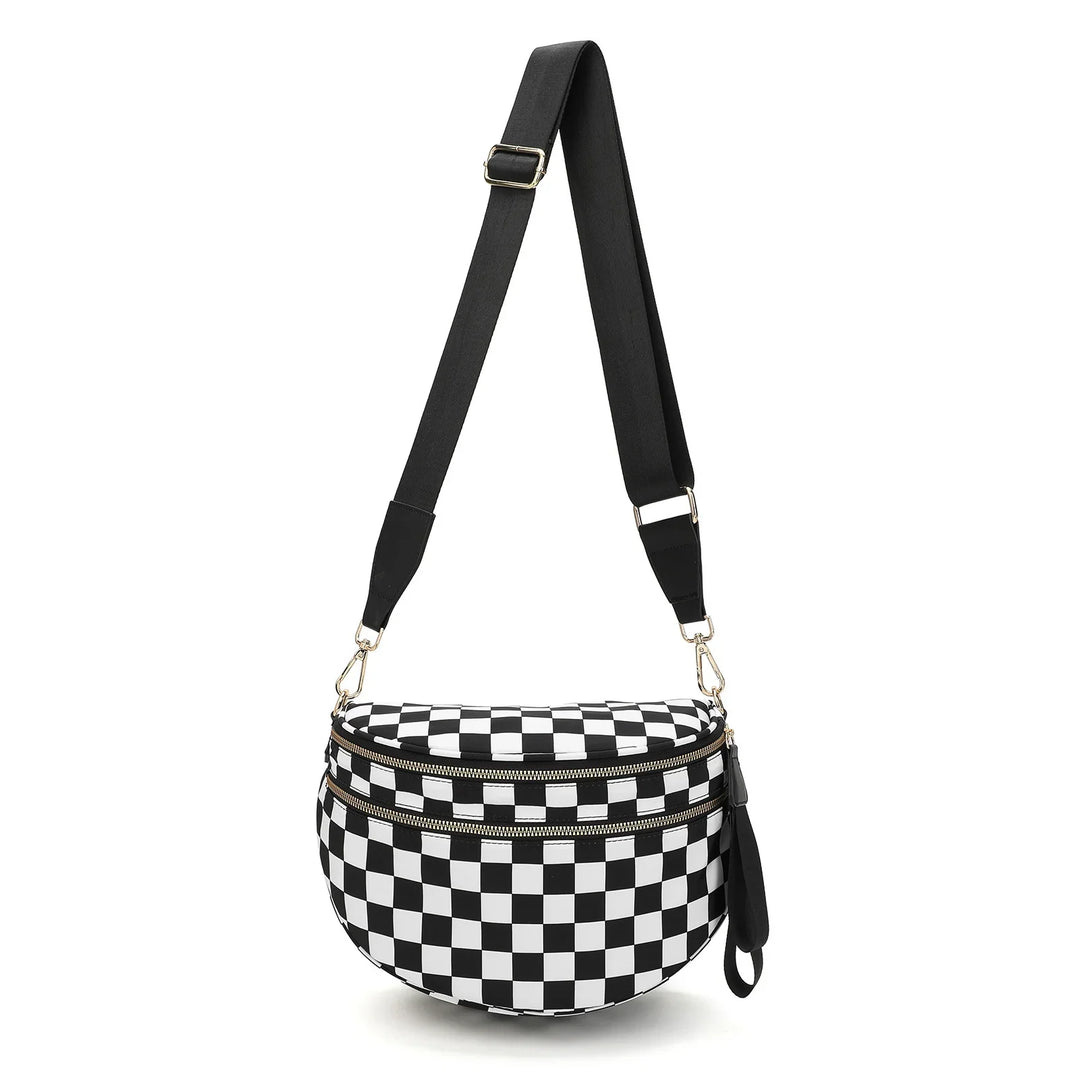 Black and white checkered pattern crossbody bag with adjustable black strap and gold zippers