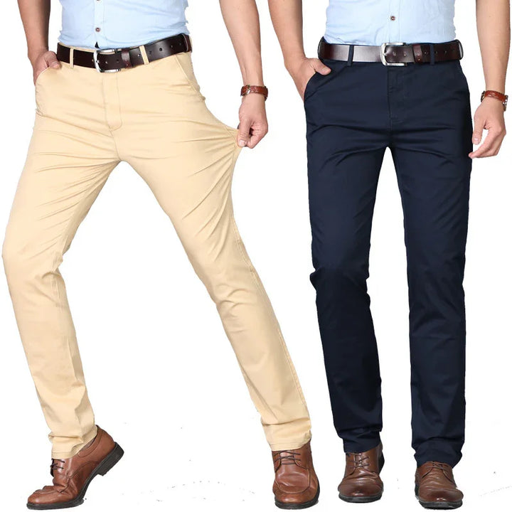 Two men wearing stretchable casual chinos in beige and navy blue with brown leather belts and shoes