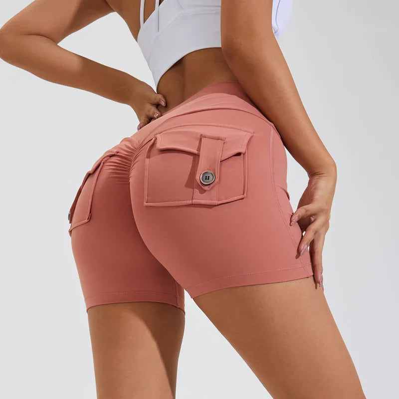 woman wearing pink high-waisted shorts with buttoned rear pockets and ruched detailing