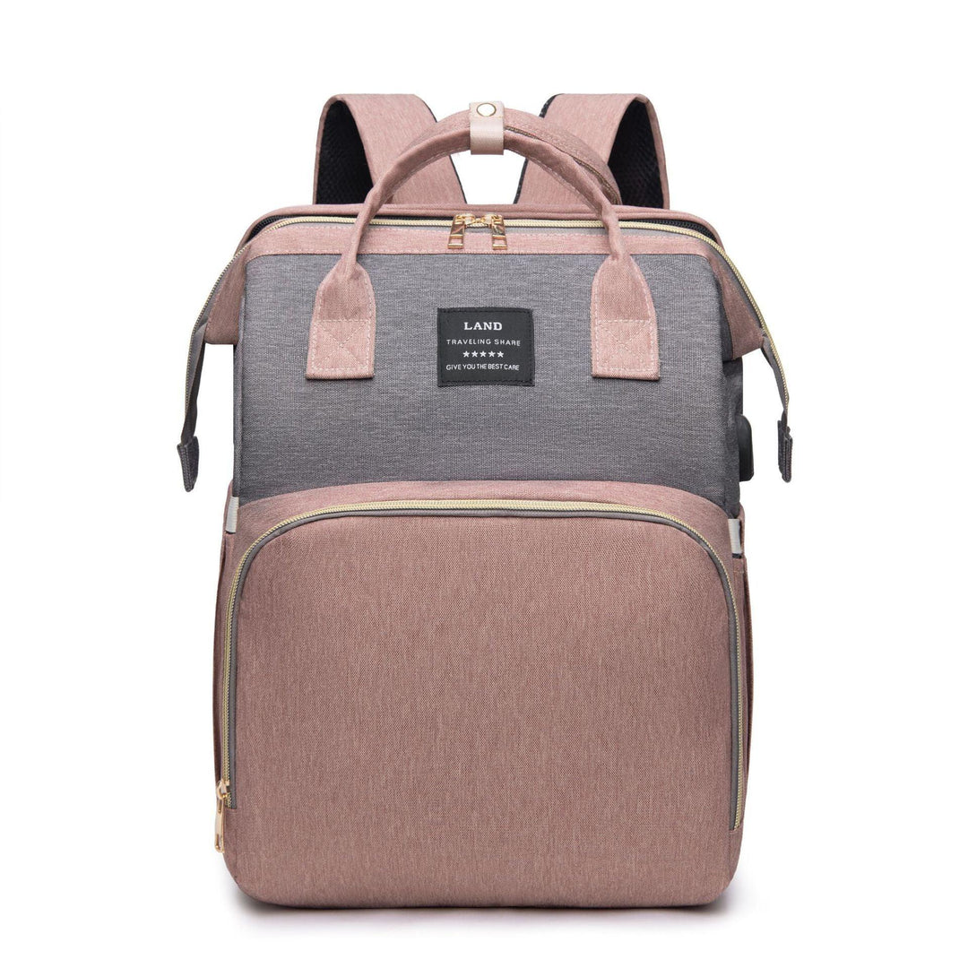 Pink and gray travel backpack with dual handles, front zip pocket, and black label