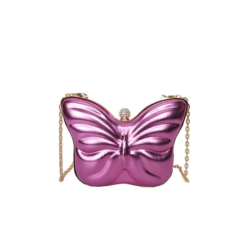 Metallic purple butterfly-shaped handbag with gold chain strap and jeweled clasp