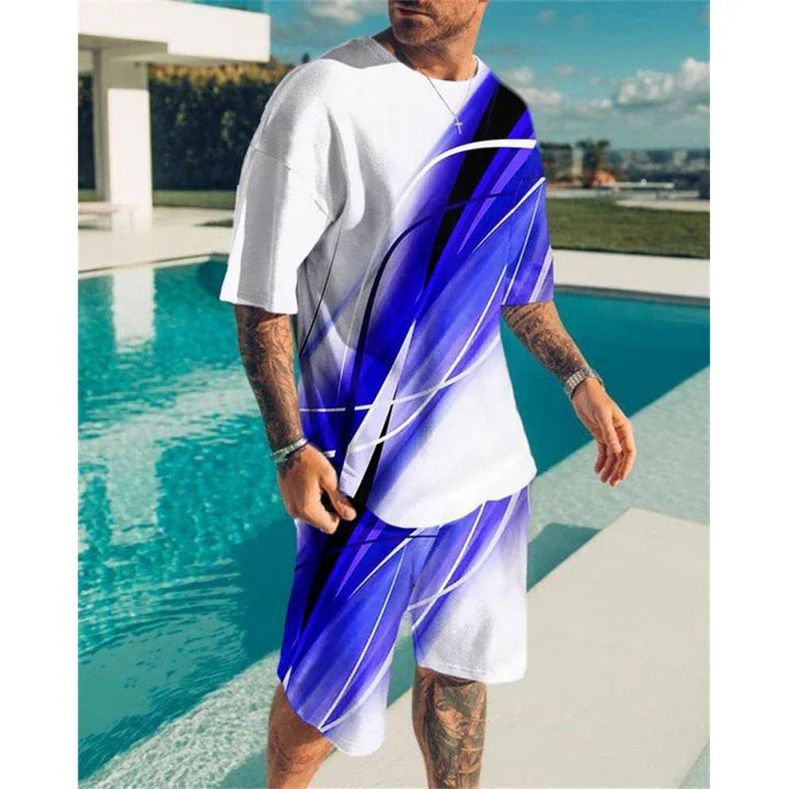 Man wearing matching white and blue abstract graphic t-shirt and shorts standing by outdoor pool