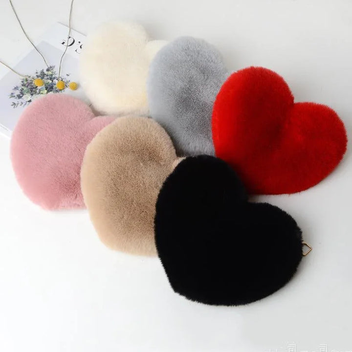 Heart-shaped plush fur keychains in pink, beige, black, red, gray, and white colors on white background