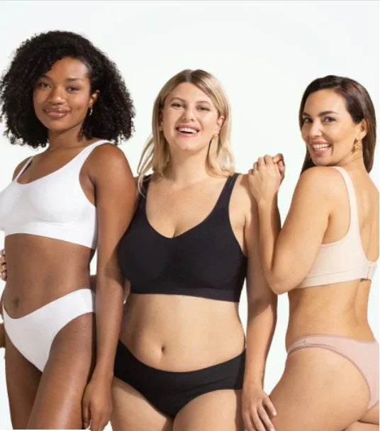 Three women of diverse sizes modeling comfortable wireless bras and matching underwear in white, black, and nude colors