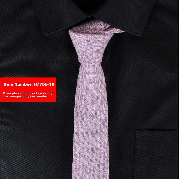 Light pink textured tie on a black dress shirt showcasing slim tie fashion style