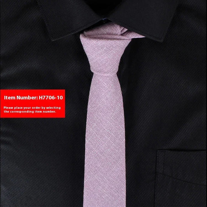 Light pink textured tie on a black dress shirt showcasing slim tie fashion style
