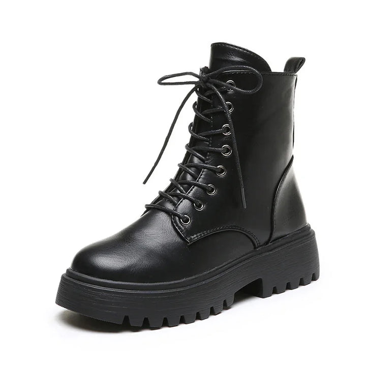 Black leather lace-up combat boot with thick lug sole and ankle pull tab on white background