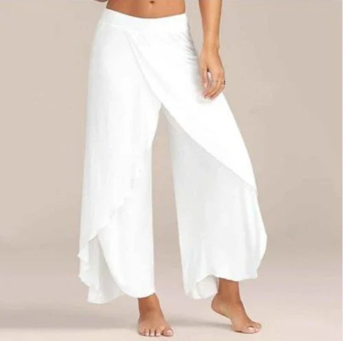 Woman wearing stylish white wrap palazzo pants with wide legs and elastic waistband barefoot