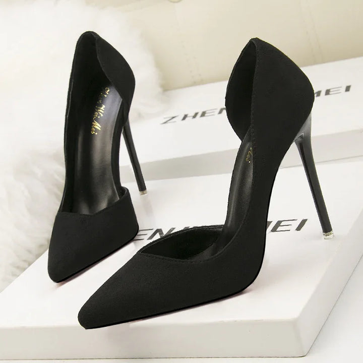 Elegant black high heel stiletto pumps with pointed toes displayed on white branded shoe boxes