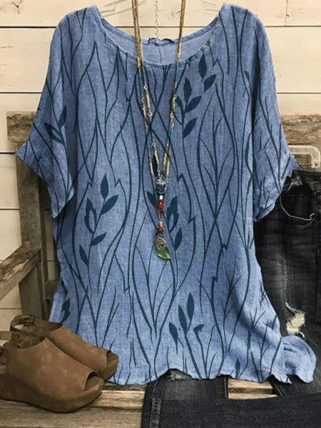 Blue casual short-sleeve shirt with dark leaf pattern, paired with ripped jeans and brown peep-toe shoes