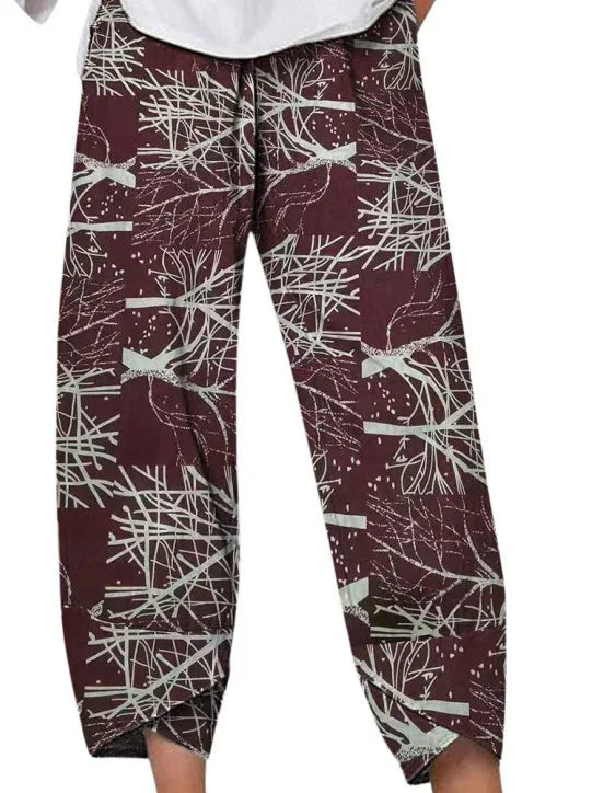 Maroon pants with white abstract tree branch pattern and elastic cuffs