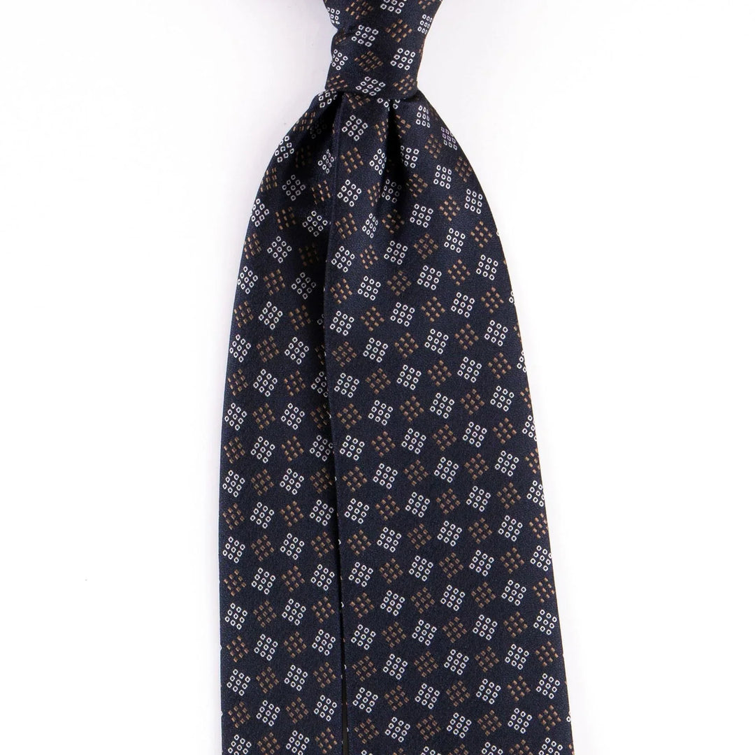 Navy blue silk necktie with small brown and white geometric diamond pattern