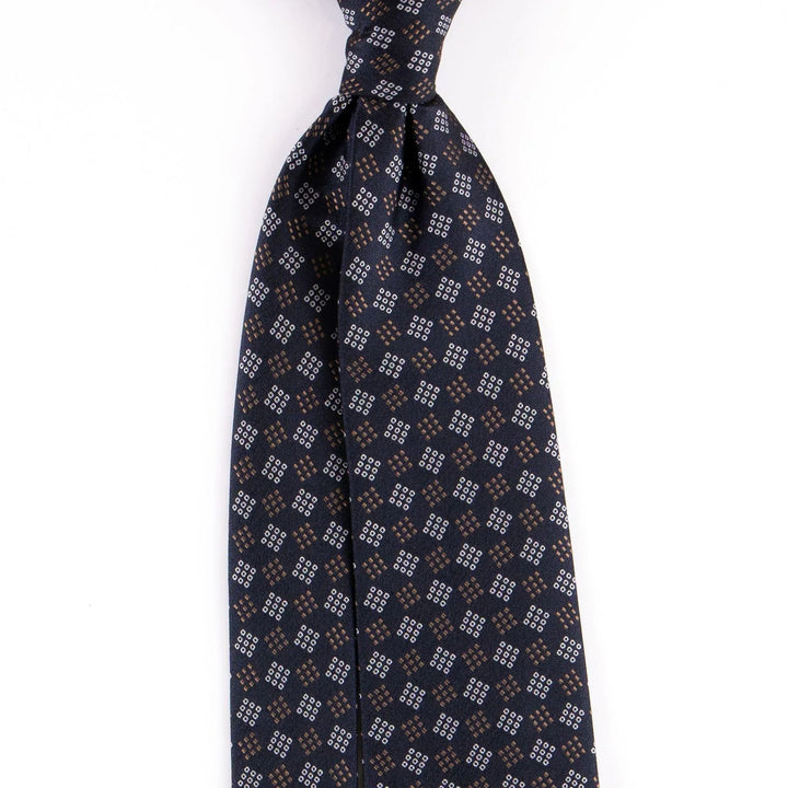 Navy blue silk necktie with small brown and white geometric diamond pattern