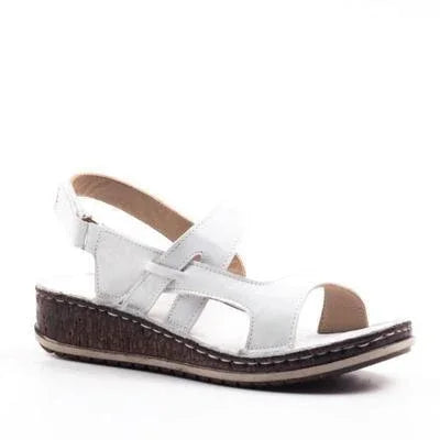 White leather women's wedge sandal with adjustable ankle strap and textured brown sole