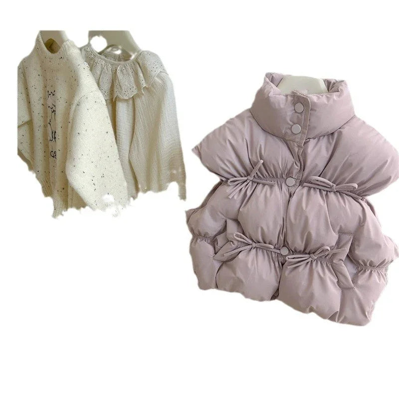 Light purple padded winter vest with snap buttons and cinched waist, cream knit sweaters with textured and lace details