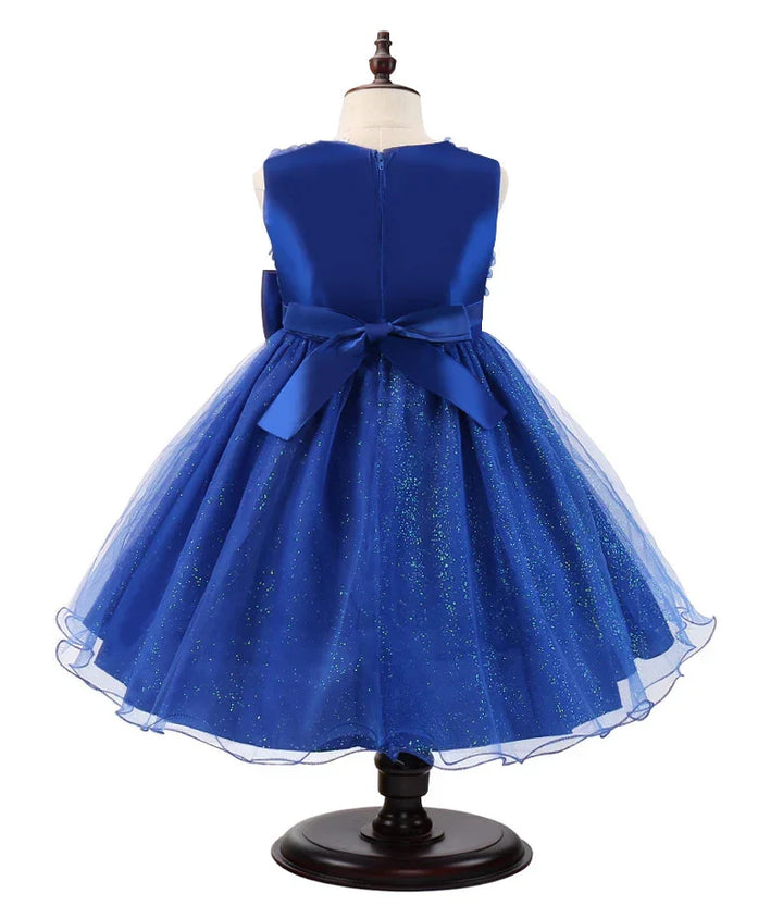 Back view of elegant blue glittery tulle dress for girls with satin bow on mannequin