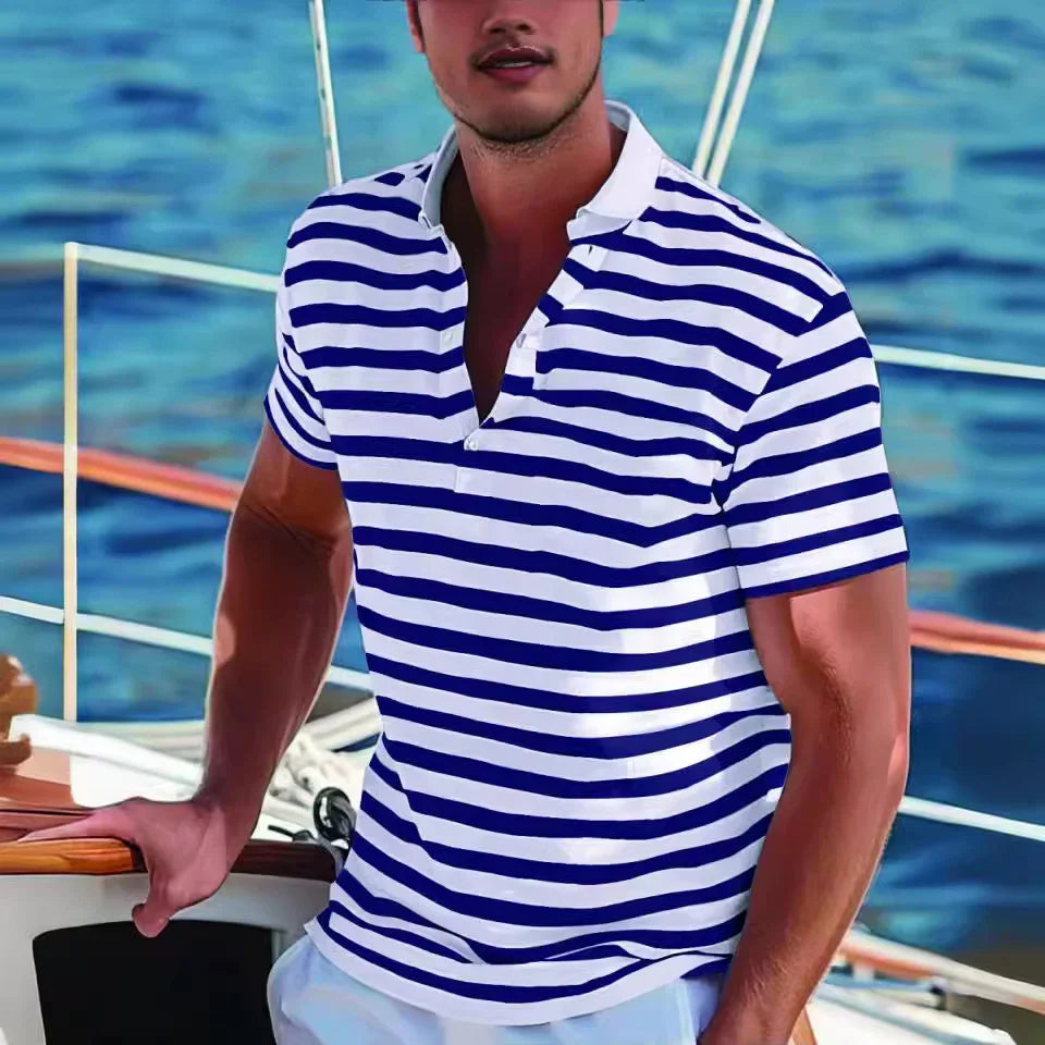 Man wearing blue and white striped polo shirt on a sailboat with water background