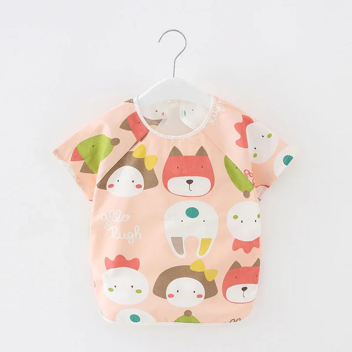 Peach kids' short-sleeve shirt with cute animal and character faces, cartoon style design
