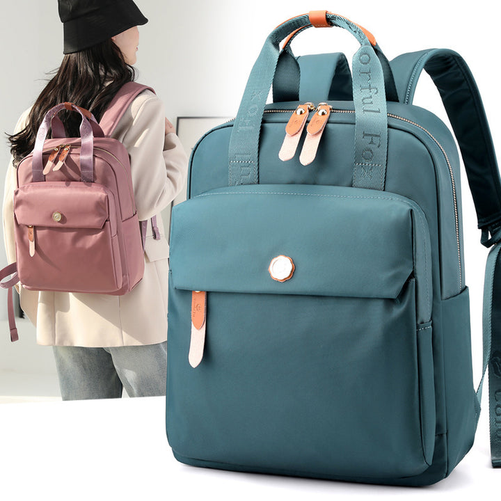 Stylish blue and pink backpacks with leather zipper pulls and front pockets, woman wearing pink backpack