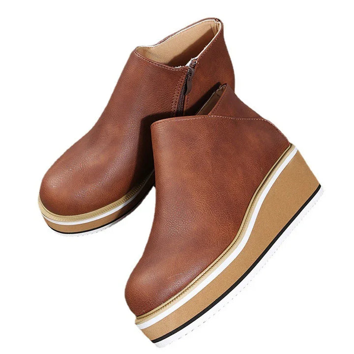 Brown leather wedge platform ankle boots with side zipper and white sole accents