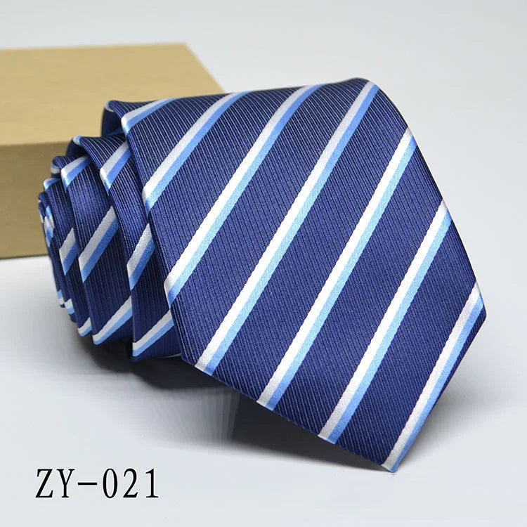 Blue striped men's necktie with white and light blue diagonal stripes, folded on white surface