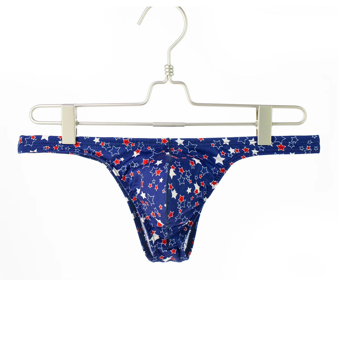 Blue men's thong underwear with red and white star pattern hanging on metal hanger
