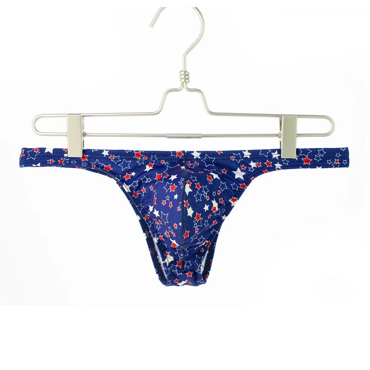 Blue men's thong underwear with red and white star pattern hanging on metal hanger