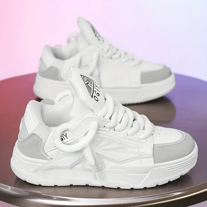 Pair of white and gray modern sneakers with thick soles on reflective surface