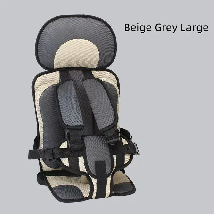 Beige and grey large child safety car seat with padded straps on grey background